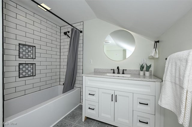 bathroom featuring tile patterned floors, lofted ceiling, vanity, and shower / bath combo