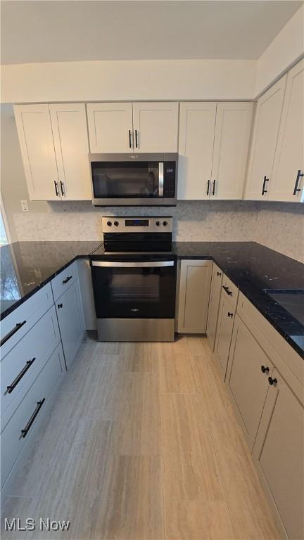 kitchen with appliances with stainless steel finishes and white cabinetry