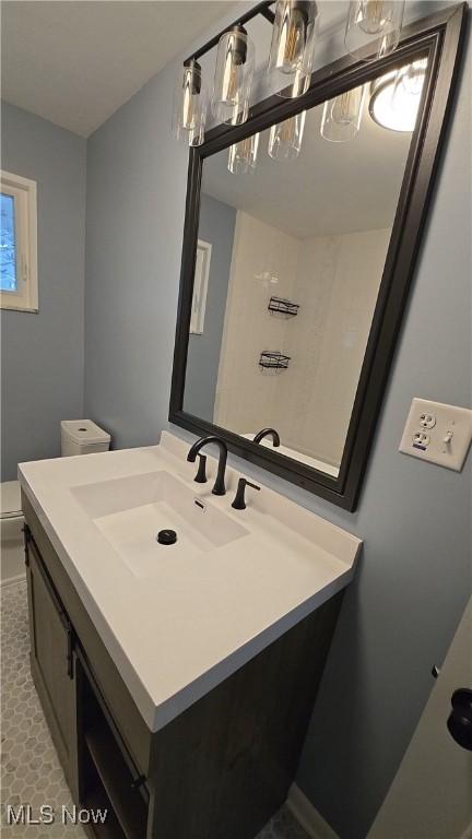 bathroom featuring vanity and toilet