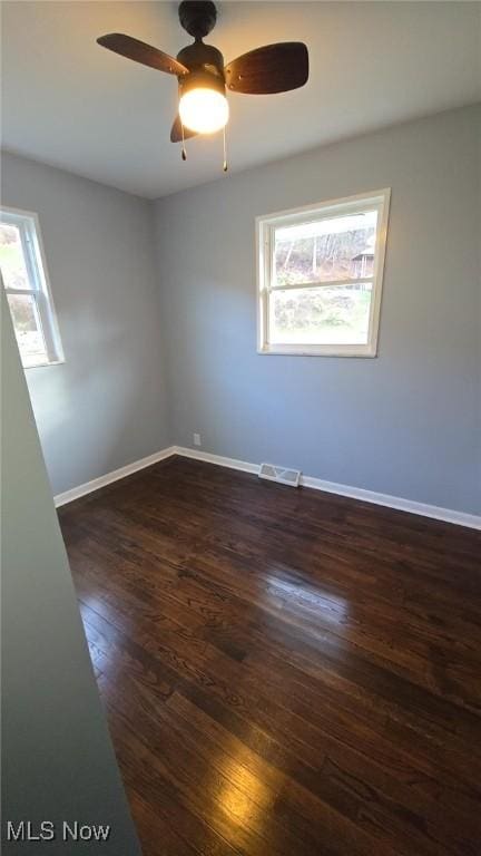 unfurnished room with dark wood-type flooring