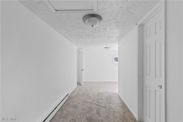 hallway featuring light carpet and a textured ceiling