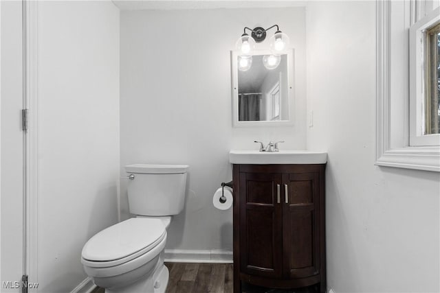 bathroom featuring vanity, toilet, and wood-type flooring