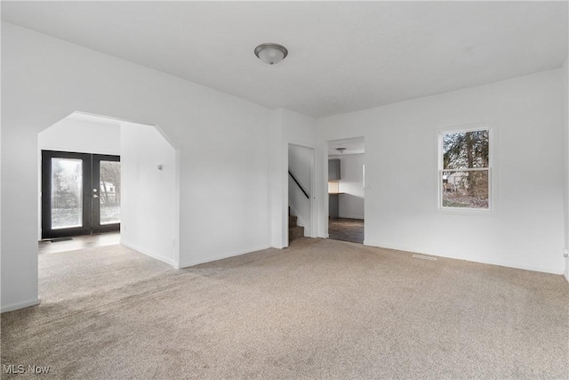 spare room with carpet flooring and french doors