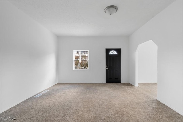 view of carpeted foyer entrance