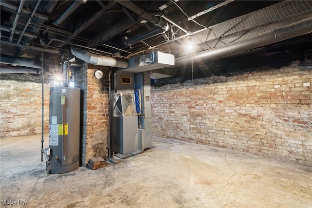 basement with brick wall, heating unit, and water heater