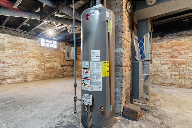 utility room featuring electric panel and water heater