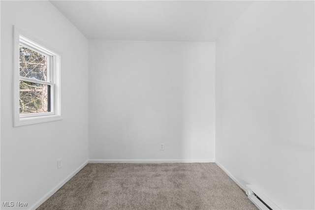 empty room featuring carpet floors and a baseboard radiator