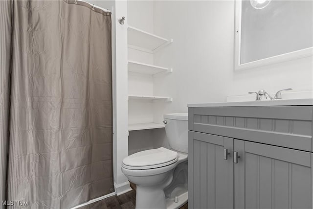 bathroom featuring hardwood / wood-style flooring, vanity, and toilet