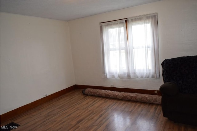 sitting room featuring plenty of natural light and dark wood-type flooring