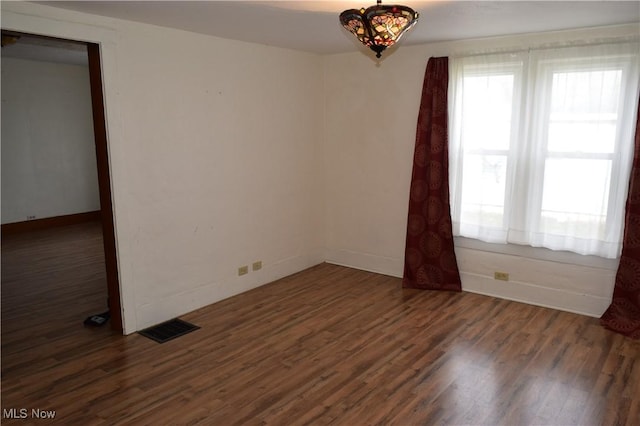 unfurnished room featuring dark hardwood / wood-style flooring