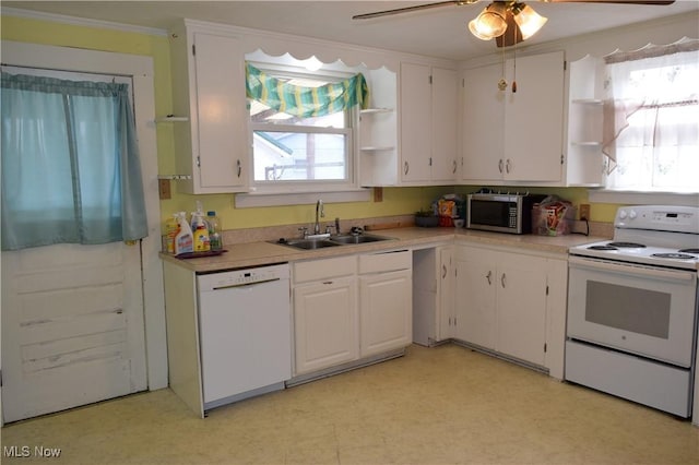 kitchen with white appliances, ceiling fan, crown molding, sink, and white cabinets