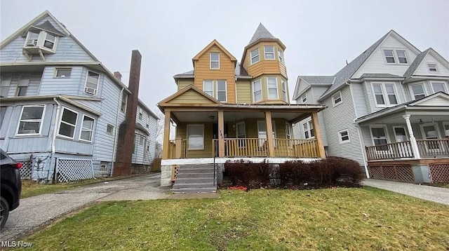 victorian house with a porch and a front yard