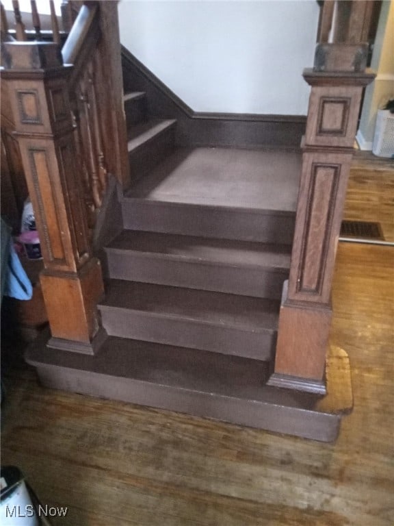 stairway with hardwood / wood-style flooring