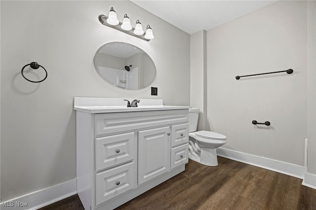 bathroom with vanity, toilet, wood-type flooring, and a shower