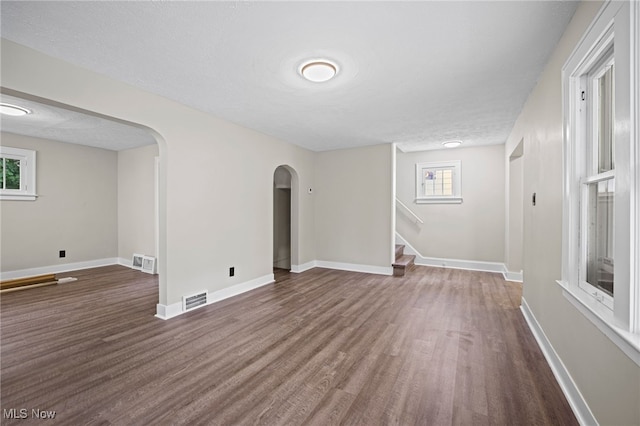 spare room with dark hardwood / wood-style flooring and a textured ceiling