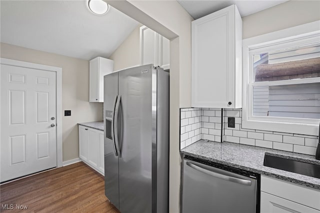 kitchen with white cabinetry, light stone countertops, dark hardwood / wood-style flooring, backsplash, and appliances with stainless steel finishes