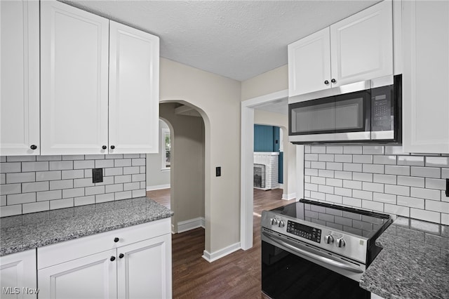 kitchen featuring tasteful backsplash, white cabinetry, and stainless steel appliances