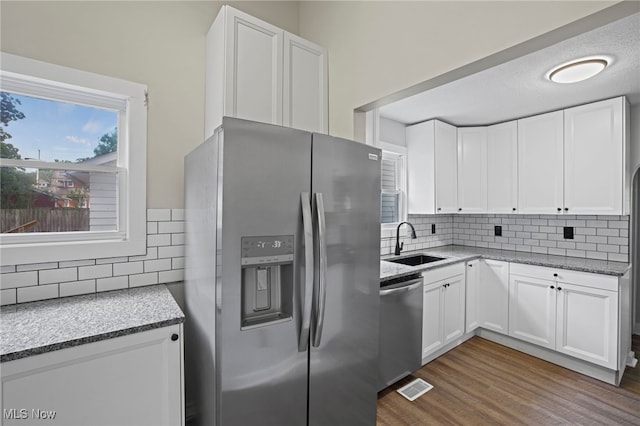 kitchen with white cabinetry, sink, appliances with stainless steel finishes, and dark wood-type flooring