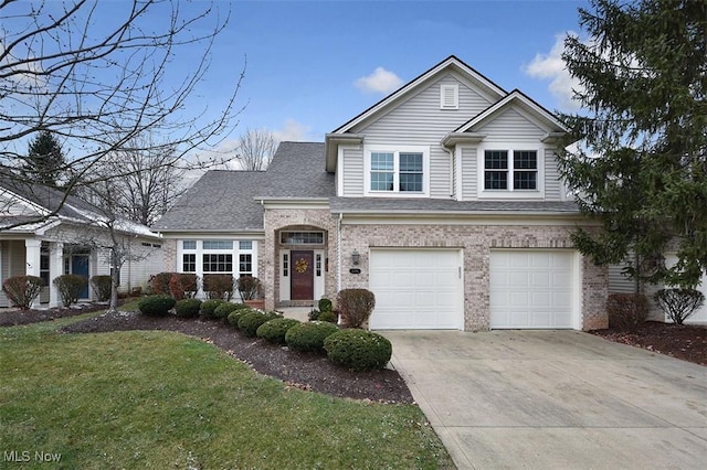 view of property featuring a front yard and a garage