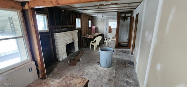 bathroom featuring a brick fireplace and a healthy amount of sunlight