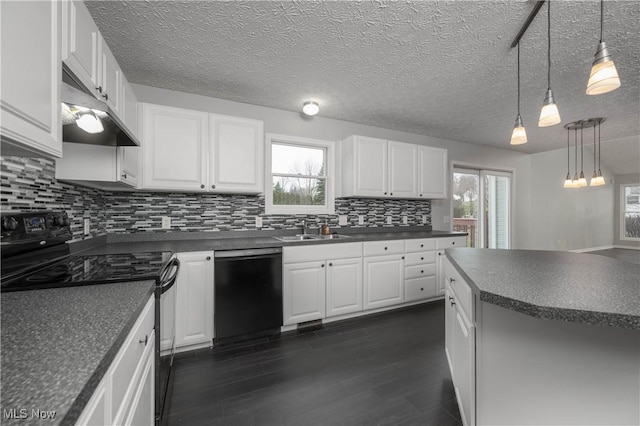 kitchen featuring pendant lighting, sink, white cabinetry, and black appliances