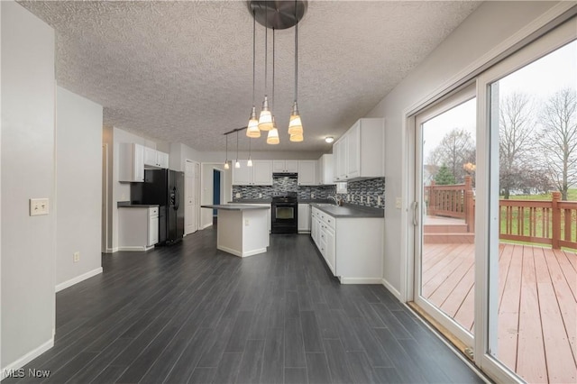 kitchen featuring a center island, black appliances, white cabinets, dark hardwood / wood-style floors, and decorative light fixtures