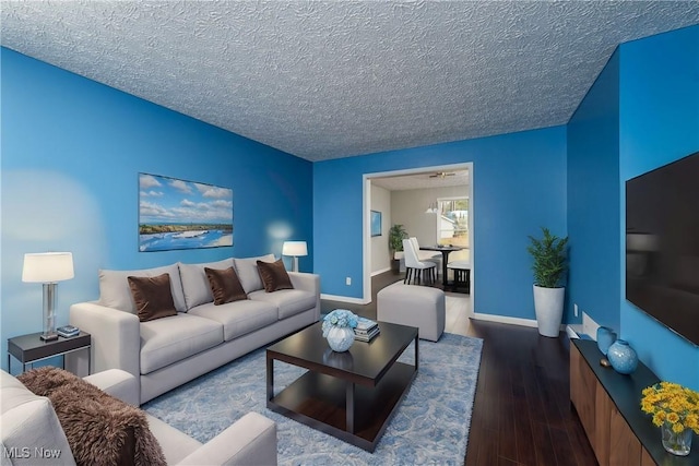 living room with wood-type flooring and a textured ceiling