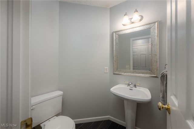 bathroom featuring toilet and sink