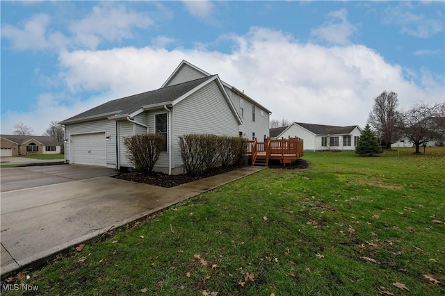 view of side of home featuring a lawn, a garage, and a wooden deck