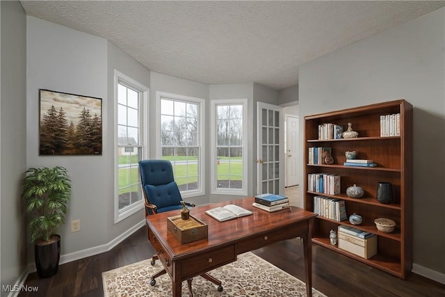 home office featuring a textured ceiling and dark hardwood / wood-style flooring