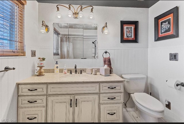 bathroom featuring a shower with shower curtain, vanity, and toilet