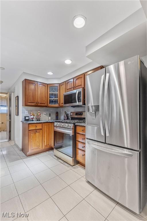 kitchen featuring appliances with stainless steel finishes and light tile patterned floors