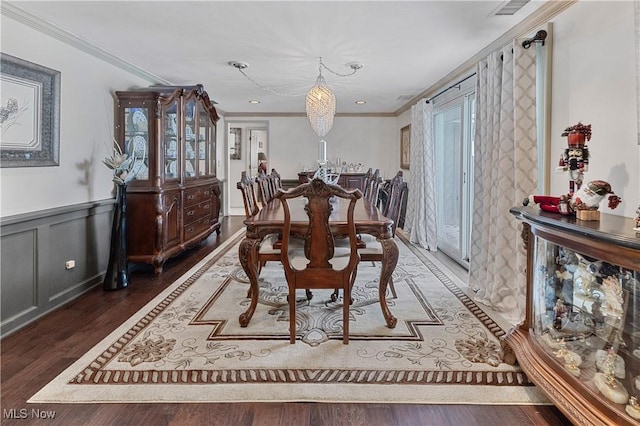 dining space with a notable chandelier, crown molding, and dark wood-type flooring