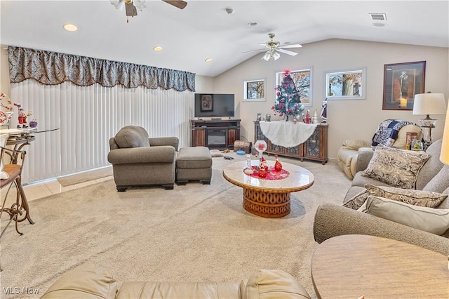 carpeted living room featuring ceiling fan and vaulted ceiling