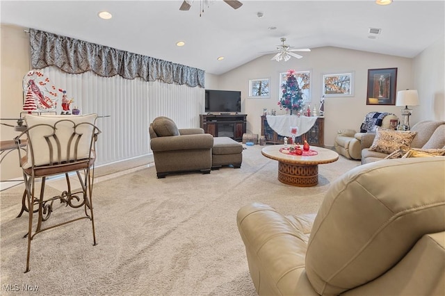 carpeted living room featuring ceiling fan and vaulted ceiling