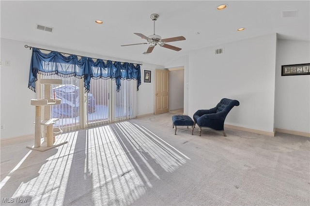 sitting room featuring ceiling fan and light carpet