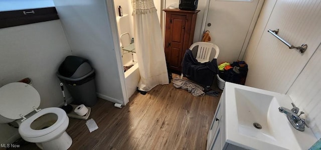 bathroom featuring toilet, shower / tub combo, and hardwood / wood-style flooring