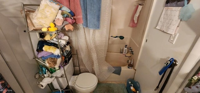 bathroom with tile patterned flooring, shower / bath combo, and toilet