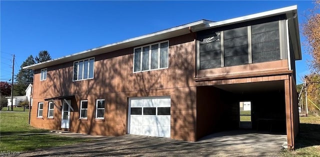 rear view of property with a garage