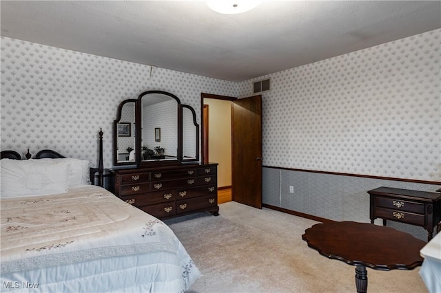 carpeted bedroom with a textured ceiling