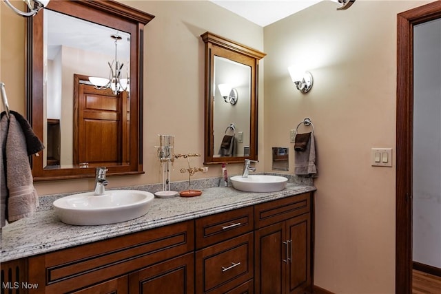 bathroom with vanity, wood-type flooring, and a chandelier