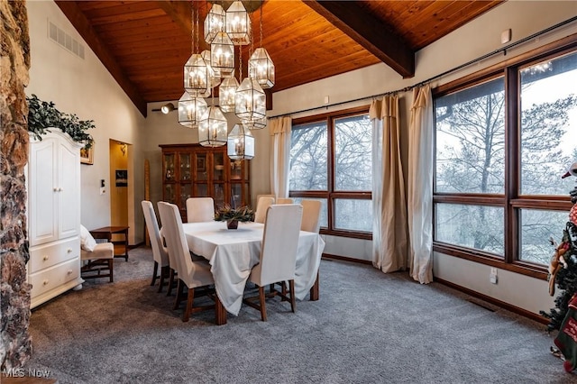 carpeted dining area with vaulted ceiling with beams, wooden ceiling, and a chandelier