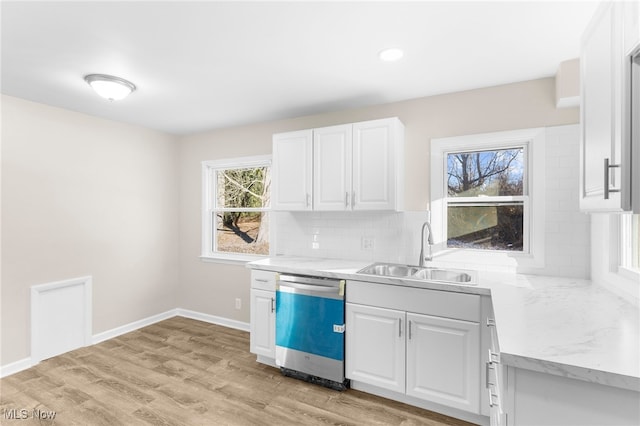 kitchen featuring dishwasher, light hardwood / wood-style flooring, a healthy amount of sunlight, and sink