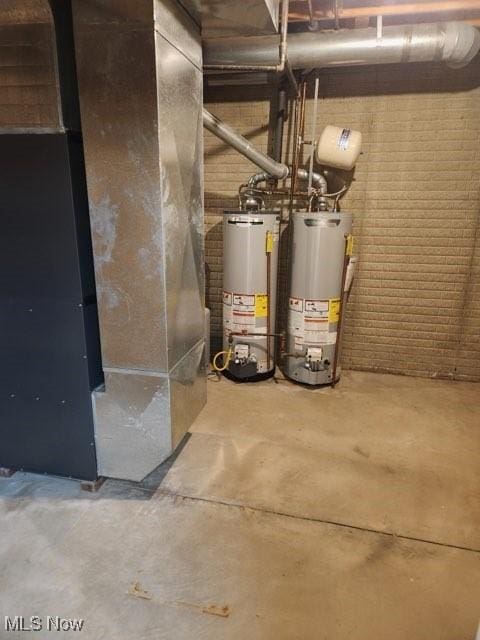 utility room featuring heating unit and gas water heater