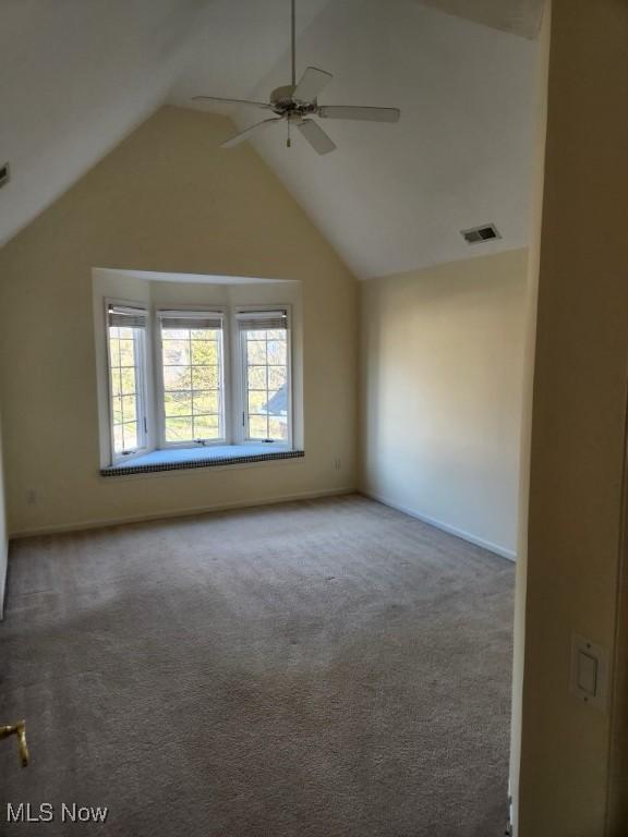 additional living space featuring ceiling fan, lofted ceiling, and carpet floors