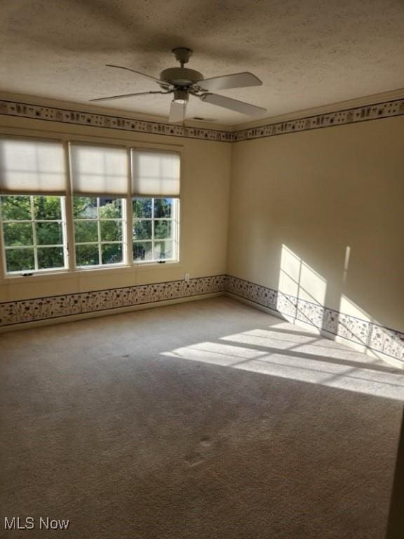 carpeted empty room with a textured ceiling and ceiling fan