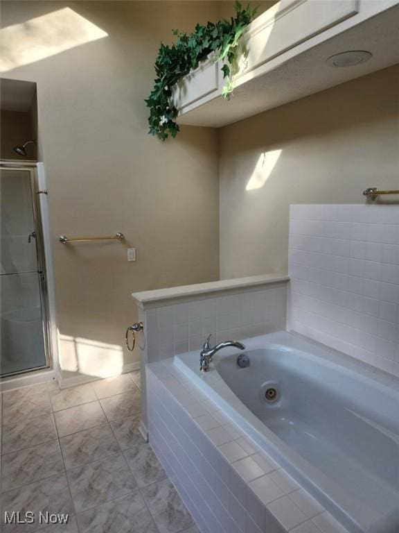 bathroom featuring separate shower and tub