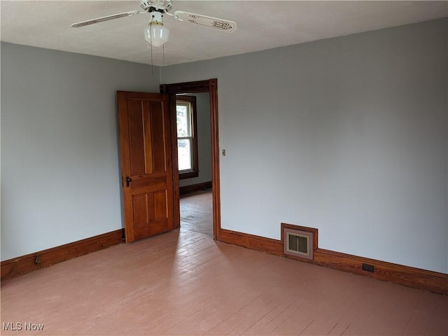 spare room featuring light hardwood / wood-style flooring and ceiling fan