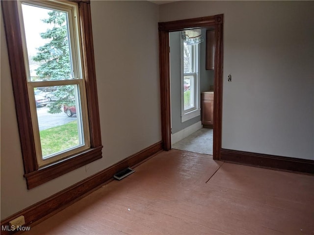 unfurnished room with light wood-type flooring