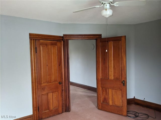 bedroom featuring ceiling fan and light carpet